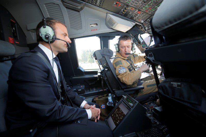 French President Emmanuel Macron sits in the cockpit of an Airbus A400M turboprop transport plane before taking off from Villacoublay military airbase near Paris, France, June 19, 2017. REUTERS/Michel Euler/Pool