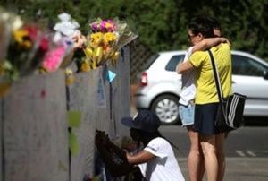 People react next to tributes to the victims of the Grenfell Tower fire near the site of the blaze in North Kensington, London, Britain, June 19, 2017. (Marko Djurica/Reuters)