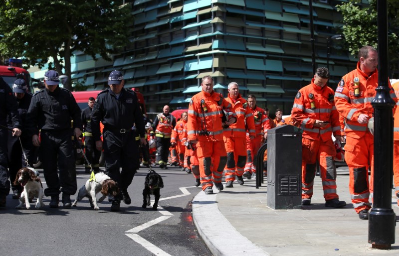 Members of the emergency services arrive to attend a minute's silence for the victims of the Grenfell Tower fire near the site of the blaze in North Kensington, London, Britain on June 19, 2017. (REUTERS/Marko Djurica)