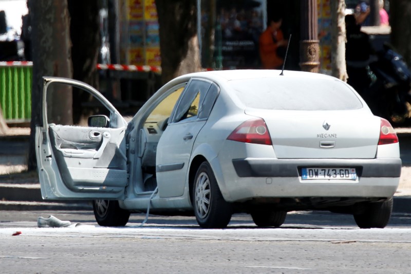 A burned car is seen on the Champs Elysees avenue after an incident in Paris, France, June 19, 2017. REUTERS/Charles Platiau