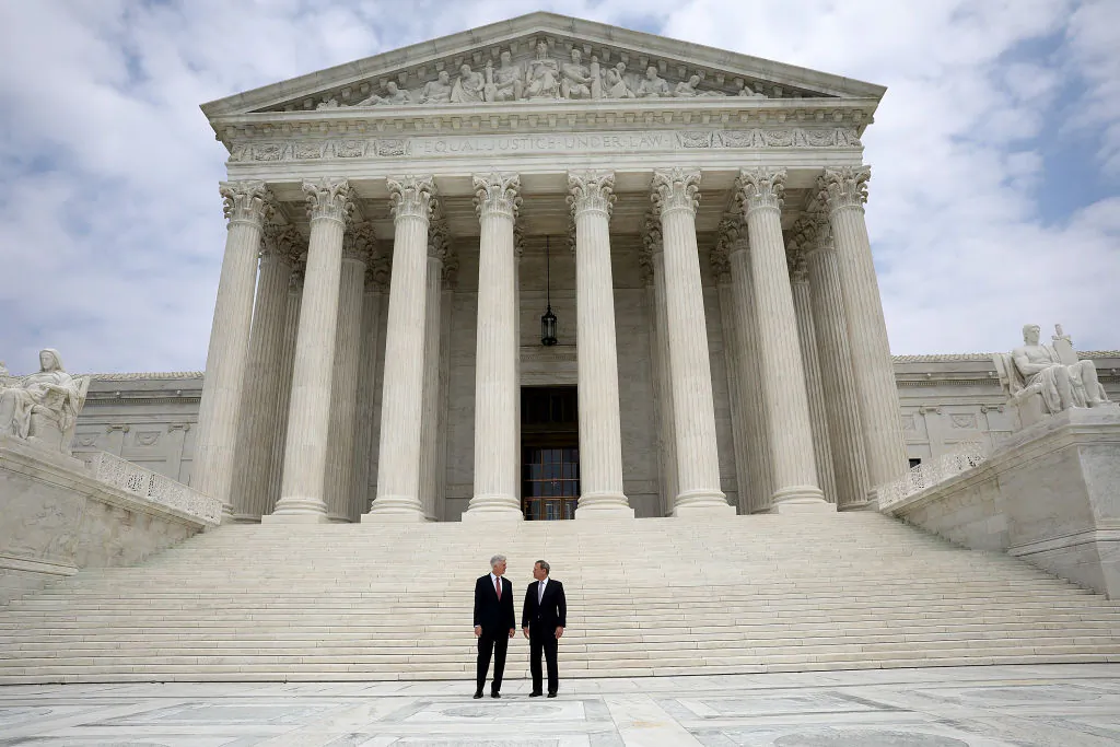 Supreme Court Justice Neil Gorsuch (L) stands with Chief Justice John Roberts (R) at the Supreme Court June 15, 2017 in Washington, DC.  (Win McNamee/Getty Images)