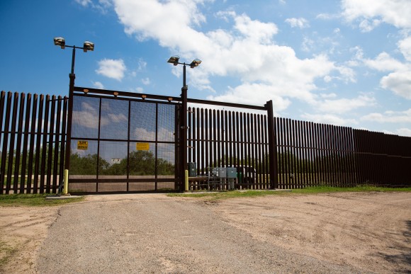 A portion of the steel border fence with a gate near Noelia Guerra's house in Brownsville, Texas, on June 1, 2017. (Benjamin Chasteen/The Epoch Times)