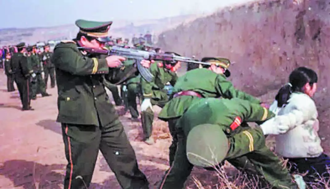 A woman before being executed by a communist soldier in China in this file photo.