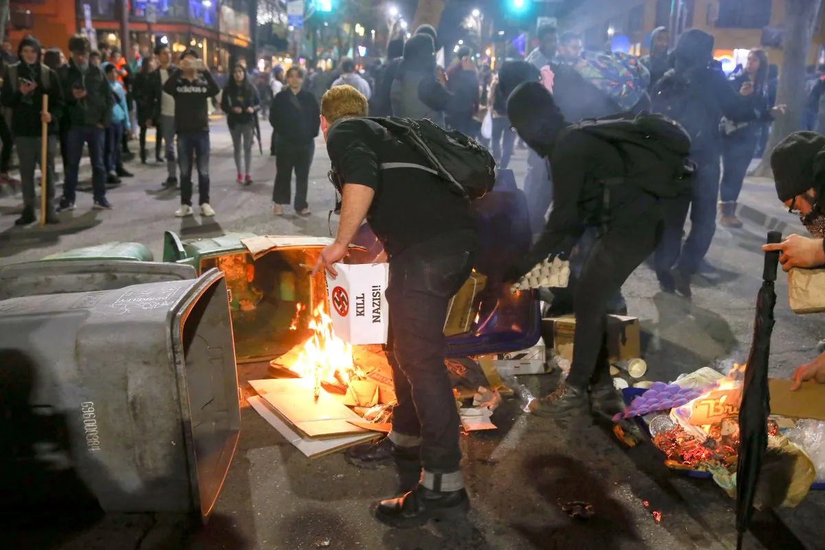 People burn trash in the street in Berkeley, California, on Feb. 1, 2017, during a violent protest over a scheduled speech by far-right commentator Milo Yiannopoulos at the University of California, Berkeley. The speech was cancelled after massive riots broke out, causing $100,000 in damage. (Elijah Nouvelage/Getty Images)