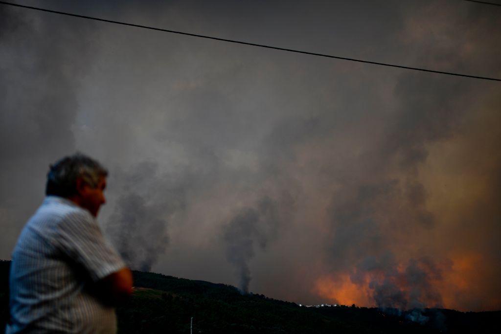 A man watches a wildfire in the village of Carvalhal, in Gois on June 20, 2017. (PATRICIA DE MELO MOREIRA/AFP/Getty Images)