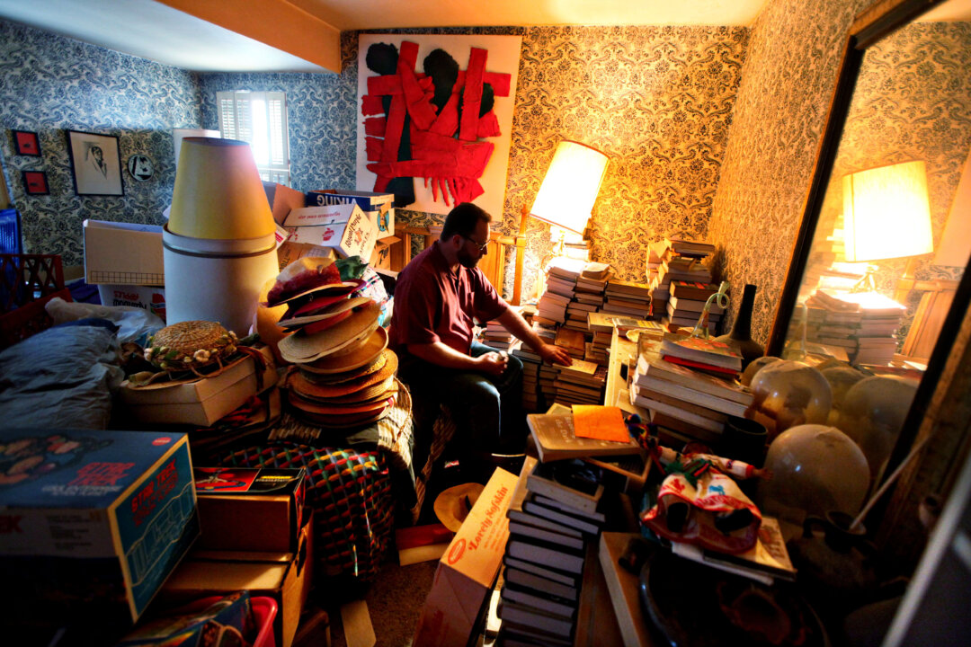 A man prepares to clean out his mother's home of belongings. (Sandy Huffaker/Getty Images for YOU Magazine)