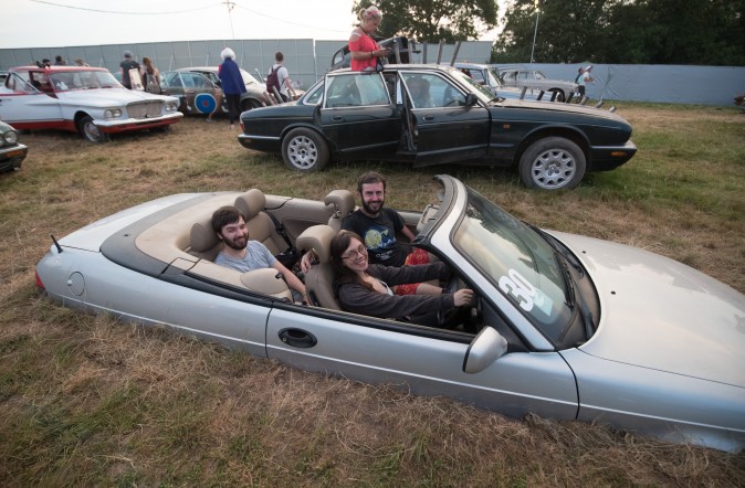 People attend a screening of film maker Julian Temple's Glastonbury documentary at the new night time area, Cinemaggedon at the Glastonbury Festival in Pilton, England, on June 21, 2017. (Matt Cardy/Getty Images)