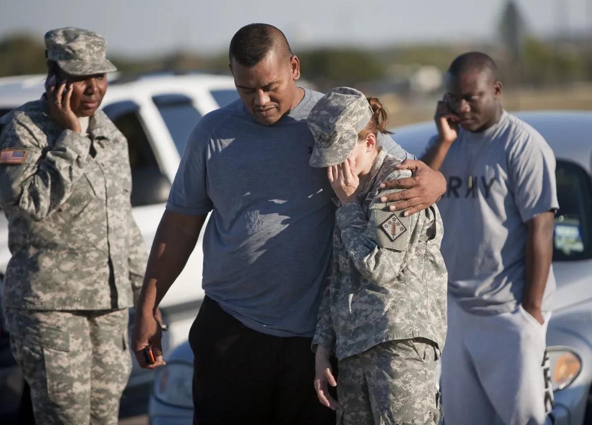 Sgt. Fanuaee Vea (L) embraces Pvt. Savannah Green after a shooting that took 13 lives in Fort Hood, Killeen, Texas, on Nov. 5, 2009. (Ben Sklar/Getty Images)