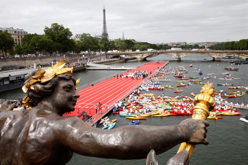 A general view from the Pont Alexandre III bridge shows an athletics track on the River Seine, with the Eiffel tower in the background, in Paris, France, June 23, 2017 as Paris is transformed into a giant Olympic park to celebrate International Olympic Days with a variety of sporting events for the public across the city during two days as the city bids to host the 2024 Olympic and Paralympic Games.  REUTERS/Charles Platiau