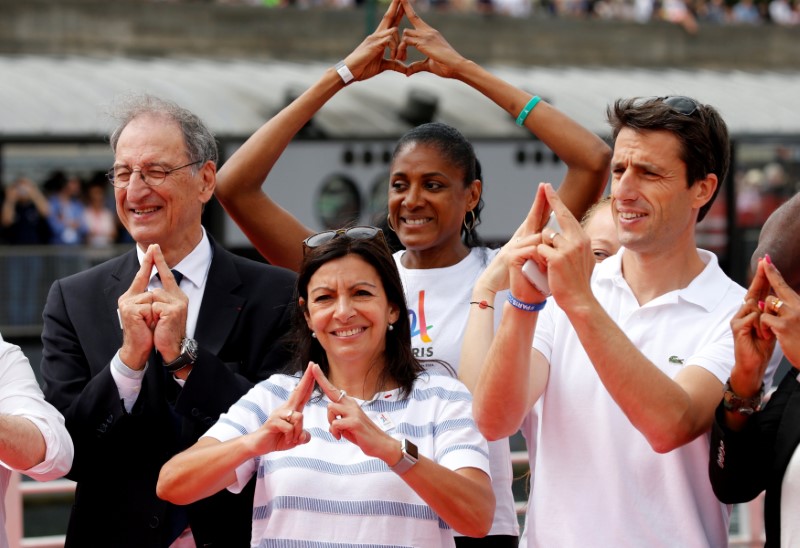 (L-R) President of the French National Olympic and Sports Committee (CNOSF) Denis Masseglia, Paris Mayor Anne Hidalgo, Olynpic champion Marie-Jose Perec, and Tony Estanguet, co-president of the Paris candicacy for the 2024 Olympics, pose on an athletics track installed on the River Seine in Paris, France, June 23, 2017 as Paris transforms into a giant Olympic park to celebrate International Olympic Days with a variety of sporting events for the public across the city during two days as the city bids to host the 2024 Olympic and Paralympic Games.  REUTERS/Jean-Paul Pelissier