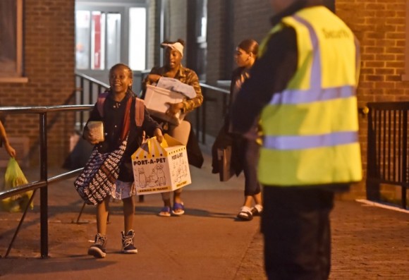 Residents are evacuated from the Taplow Tower residential block as a precautionary measure following concerns over the type of cladding used on the outside of the building on the Chalcots Estate in north London, Britain, June 23, 2017. (Reuters/Hannah McKay)