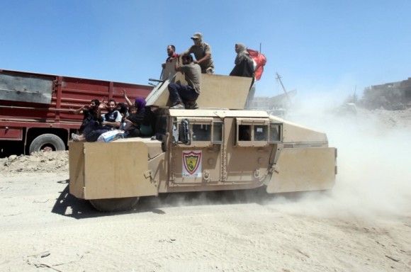 Displaced people who flee from the clashes ride in military vehicle of Iraqi security forces, in the Old City of Mosul, Iraq June 24, 2017. (Reuters/Azad Lashkari)