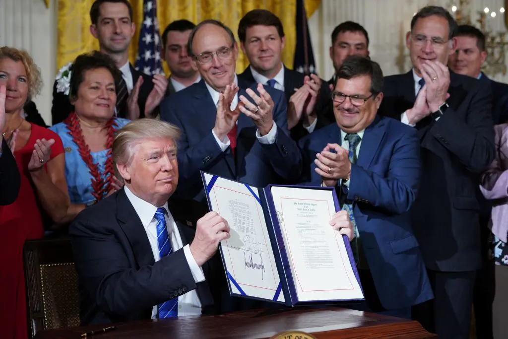 President Donald Trump holds up the bill after signing the Department of Veterans Affairs Accountability and Whistleblower Protection Act of 2017, in the East Room of the White House in Washington on June 23, 2017. (MANDEL NGAN/AFP/Getty Images)