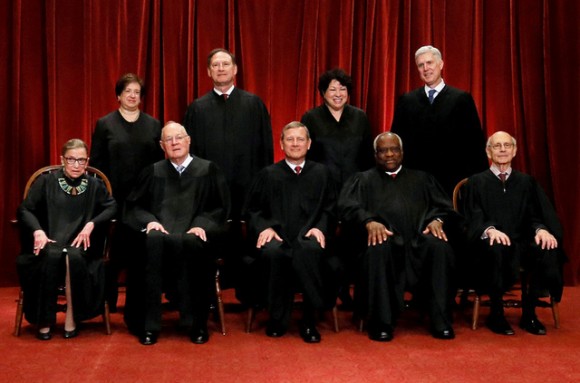FILE PHOTO: U.S. Chief Justice John Roberts (seated C) leads Justice Ruth Bader Ginsburg (front row, L-R), Justice Anthony Kennedy, Justice Clarence Thomas, Justice Stephen Breyer, Justice Elena Kagan (back row, L-R), Justice Samuel Alito, Justice Sonia Sotomayor, and Associate Justice Neil Gorsuch in taking a new family photo including Gorsuch, their most recent addition, at the Supreme Court building in Washington, D.C., U.S., on June 1, 2017. REUTERS/Jonathan Ernst/File Photo