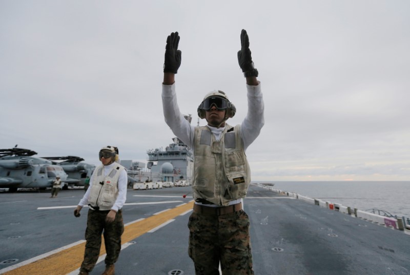 A crewman aboard the USS Bonhomme Richard amphibious assault ship guides the press off a U.S. Marines MV-22B Osprey Aircraft before a ceremony marking the start of Talisman Saber 2017, a biennial joint military exercise between the United States and Australia off the coast of Sydney, Australia, June 29, 2017.   REUTERS/Jason Reed