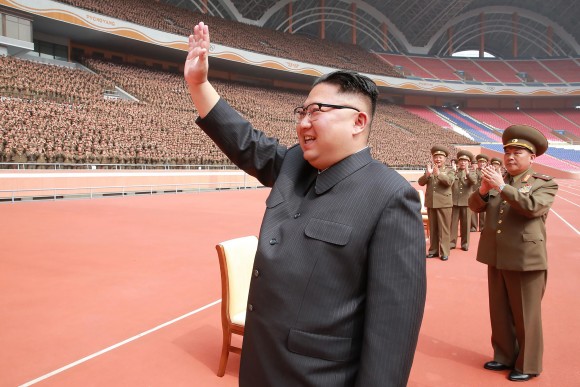 This undated picture released by North Korea's official Korean Central News Agency (KCNA) on May 15, 2017 shows North Korean leader Kim Jong-Un (L) waving to the Korean People's Army construction department officials in Pyongyang. (STR/AFP/Getty Images)