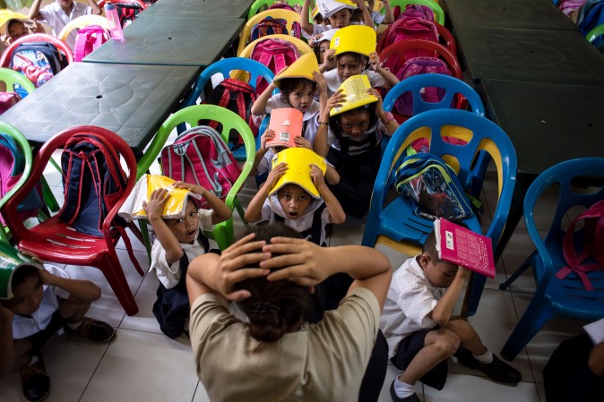 Schoolchildren from the Corazon Aquino Elementary School participate in a nationwide earthquake drill in Manila on June 29. The nationwide drill is part of the Philippine government's disaster preparedness program and is held quarterly. (NOEL CELIS/AFP/Getty Images)