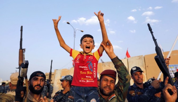 Members of Iraqi Federal Police carry a boy as they celebrate victory of military operations against the Islamic State militants in West Mosul, Iraq, July 2, 2017. (REUTERS/Erik De Castro)