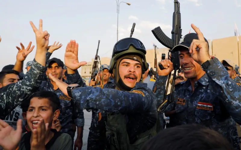 Members of Iraqi Federal Police dance and sing as they celebrate victory of military operations against the Islamic State militants in West Mosul, Iraq, July 2, 2017. (REUTERS/Erik De Castro)