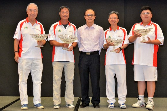Mr Kelvin Chan, Leisure Manager (Sports Funding) 1 of the Leisure and Cultural Services Department (middle), presents the Cup trophy of the Reunification Cup to the Hong Kong Football Club team. (Stephanie Worth)