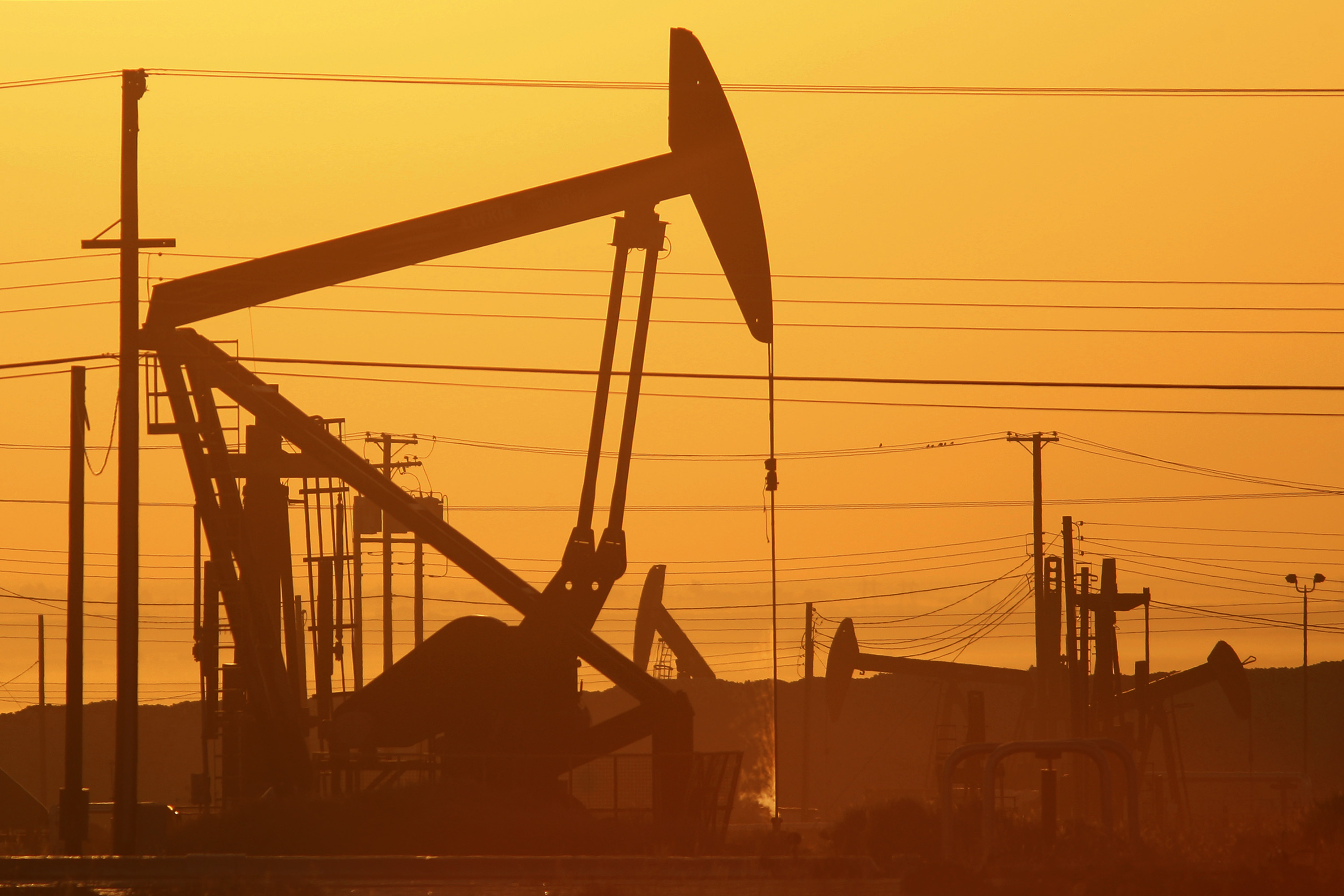 Pump jacks are seen at dawn in an oil field over the Monterey Shale formation where gas and oil extraction using hydraulic fracturing, or fracking, is on the verge of a boom on March 24, 2014 near Lost Hills, California. (David McNew/Getty Images)