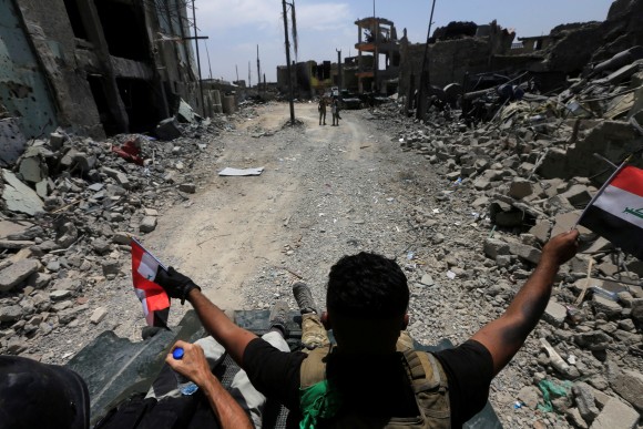 Members of the Emergency Response Division celebrate in the Old City of Mosul, Iraq July 8, 2017. (Reuters/Alaa Al-Marjani)