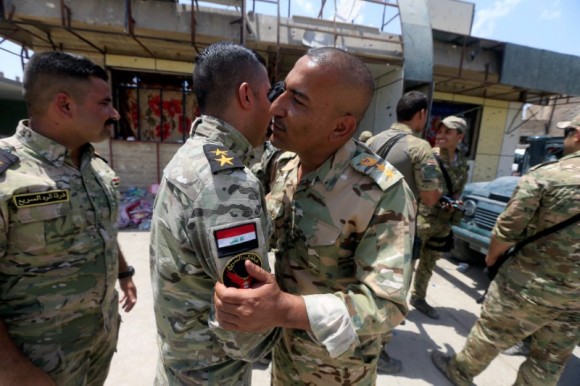 Members of the Emergency Response Division celebrate in the Old City of Mosul, Iraq July 8,2017. (Reuters/ Alaa Al-Marjani)