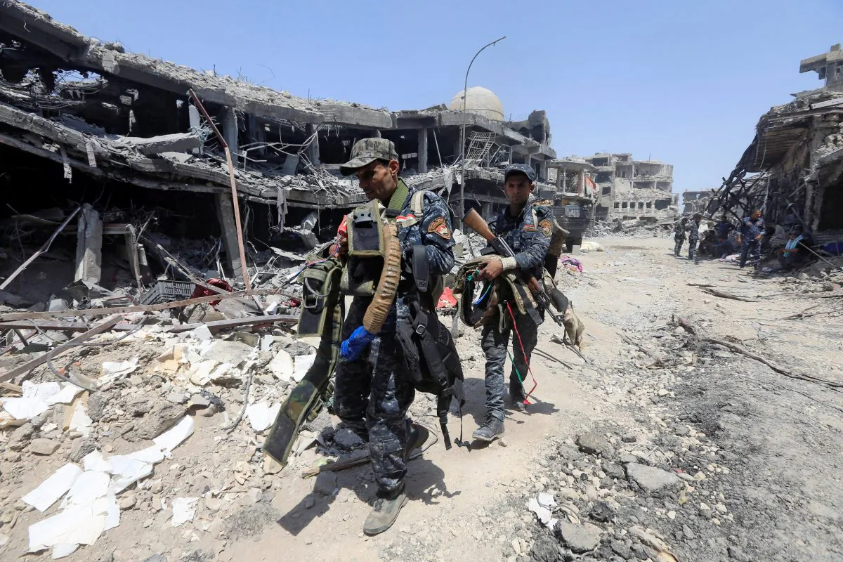 Members of Iraqi Federal police carry suicide belts used by Islamic State militants in the Old City of Mosul, Iraq. (Reuters/Alaa Al-Marjani)
