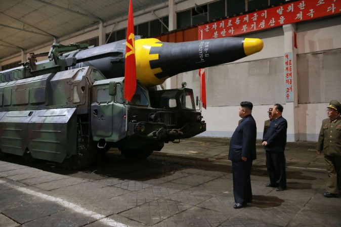 North Korean leader Kim Jong Un (L) inspects a Hwasong-12 strategic ballistic rocket at an undisclosed location in this picture released by North Korean state media on May 15. (STR/AFP/Getty Images)