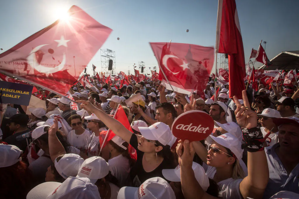 Thousands of supporters cheer and wave flags while listening to Turkey's main opposition Republican People's Party (CHP) leader Kemal Kilicdaroglu speak on stage during the "Justice Rally" in Istanbul, Turkey on July 9, 2017. (Chris McGrath/Getty Images)