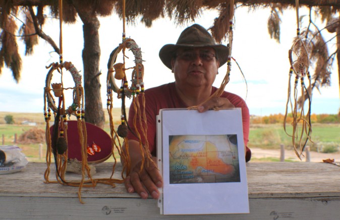 Emerson Elk following his mission of teaching visitors from a map highlighted in orange The Big Horn Mountains, Greasy Grass and Black Hills Territory ceded to the Oglala Sioux Tribe under the Treaty of 1886 and the Ft. Laramie Treaty. (Myriam Moran copyright 2014)