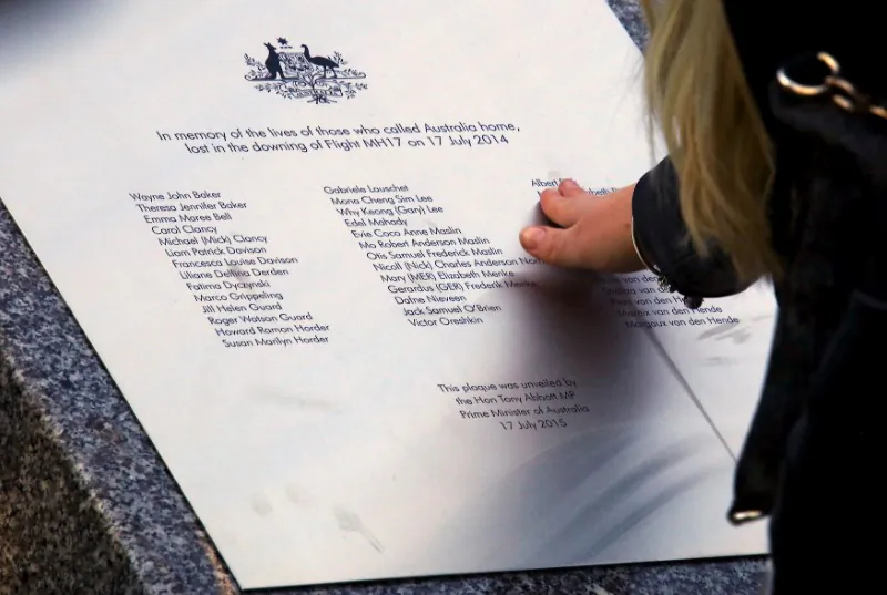 A relative of an Australian victim of Malaysia Airlines jet MH17 touches a memorial that was unveiled outside Parliament House in Canberra, Australia, July 17, 2015.   (Reuters/David Gray/File photo)