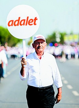 Kemal Kilicdaroglu, leader of Turkey's Republican People's Party (CHP), holds a placard that reads