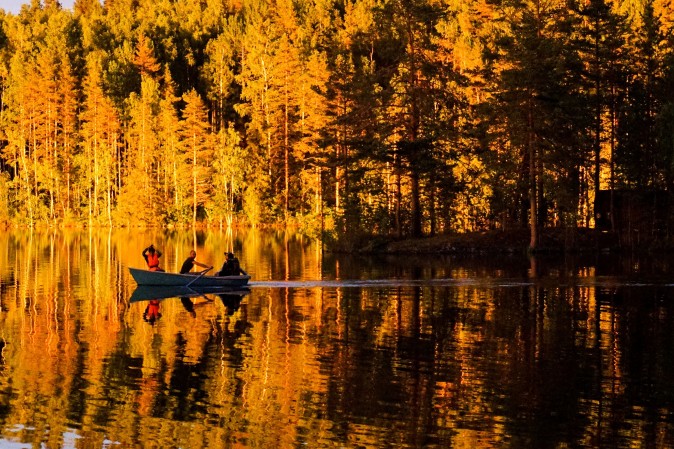 People enjoy a sunset on a lake outside the town of Sortavala, Russia, on July 17, 2017. (KIRILL KUDRYAVTSEV/AFP/Getty Images) 