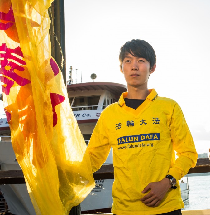 Collin Ding, with Falun Gong practitioners for a rally and a candlelight vigil n front of Chinese Consulate in New York on July 16, 2017. Ding said he was there to peacefully protest the continued persecution of his beliefs. (Benjamin Chasteen/The Epoch Times)