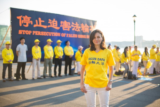 Cristina Oz with Falun Gong practitioners in front of Chinese Consulate in New York for a rally and candlelight vigil calling for an end to the persecution on July 16, 2017. (Benjamin Chasteen/The Epoch Times)
