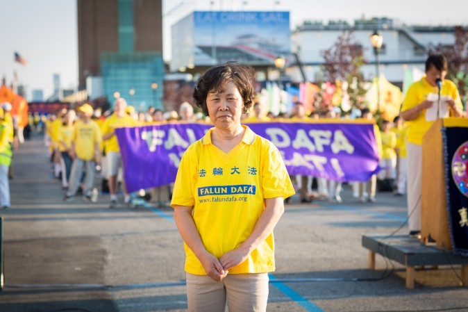 Li Dianqin with Falun Gong practitioners in front of Chinese Consulate in New York for a rally and candlelight vigil calling for an end to the persecution on July 16, 2017. (Benjamin Chasteen/The Epoch Times)