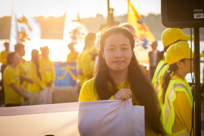 Hundreds of Falun Gong practitioners and supporters hold a candlelight vigil in front of the Chinese Consulate in New York on July 16, 2017. Launched on July 20, 1999, the persecution is now entering its 18th year inside China. (Benjamin Chasteen/The Epoch Times)