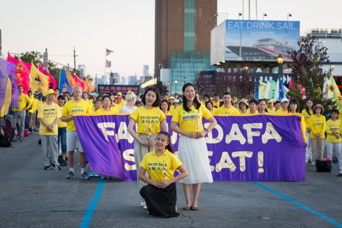Woman perform a song and dance at a rally in front of Chinese Consulate in New York calling for an end to the Falun Gong persecution inside China in New York on July 16, 2017. (Benjamin Chasteen/The Epoch Times)