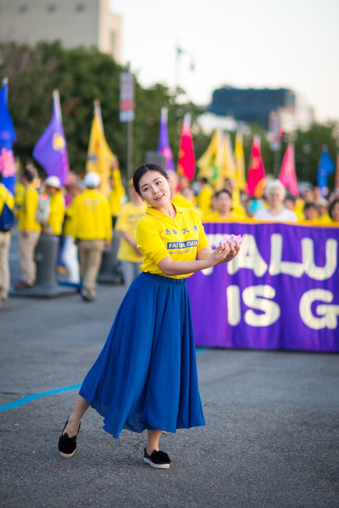 Woman perform a song and dance at a rally in front of Chinese Consulate in New York calling for an end to the Falun Gong persecution inside China in New York on July 16, 2017. (Benjamin Chasteen/The Epoch Times)