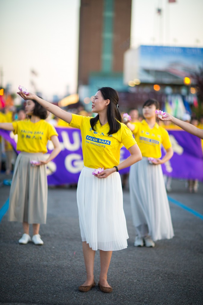 Woman perform a song and dance at a rally in front of Chinese Consulate in New York calling for an end to the Falun Gong persecution inside China in New York on July 16, 2017. (Benjamin Chasteen/The Epoch Times)