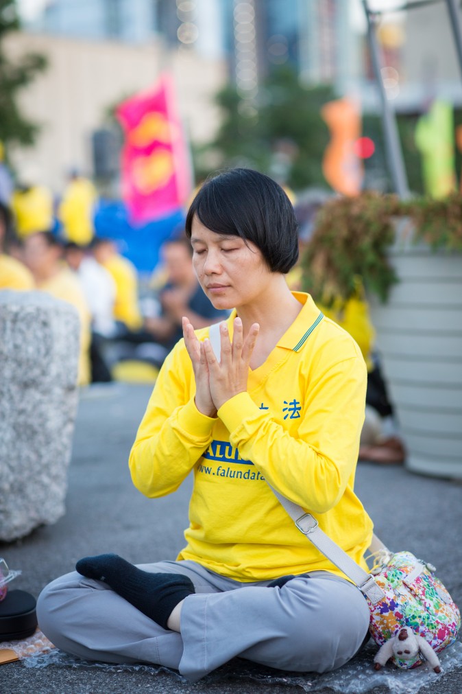 Hundreds of Falun Gong practitioners and supporters hold a candlelight vigil in front of the Chinese Consulate in New York on July 16, 2017. Launched on July 20, 1999, the persecution is now entering its 18th year inside China. (Benjamin Chasteen/The Epoch Times)