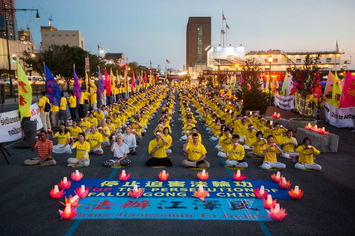Hundreds of Falun Gong practitioners and supporters, hold a candlelight vigil in front of the Chinese Consulate in New York on July 16, 2017. The persecution, now entering its 18th year, began on July 20, 1999. (Benjamin Chasteen/The Epoch Times)