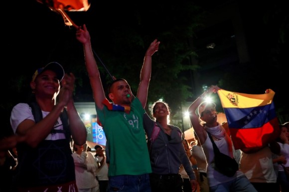Opposition supporters react while waiting for results of the unofficial plebiscite against President Nicolas Maduro's government and his plan to rewrite the constitution, in Caracas, Venezuela July 16, 2017. (Reuters/Marco Bello)