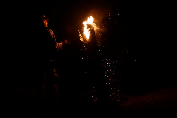 A firefighter works on a burning pole during the Detwiler fire in Mariposa, California, U.S., July 18, 2017. (Reuters/Stephen Lam)