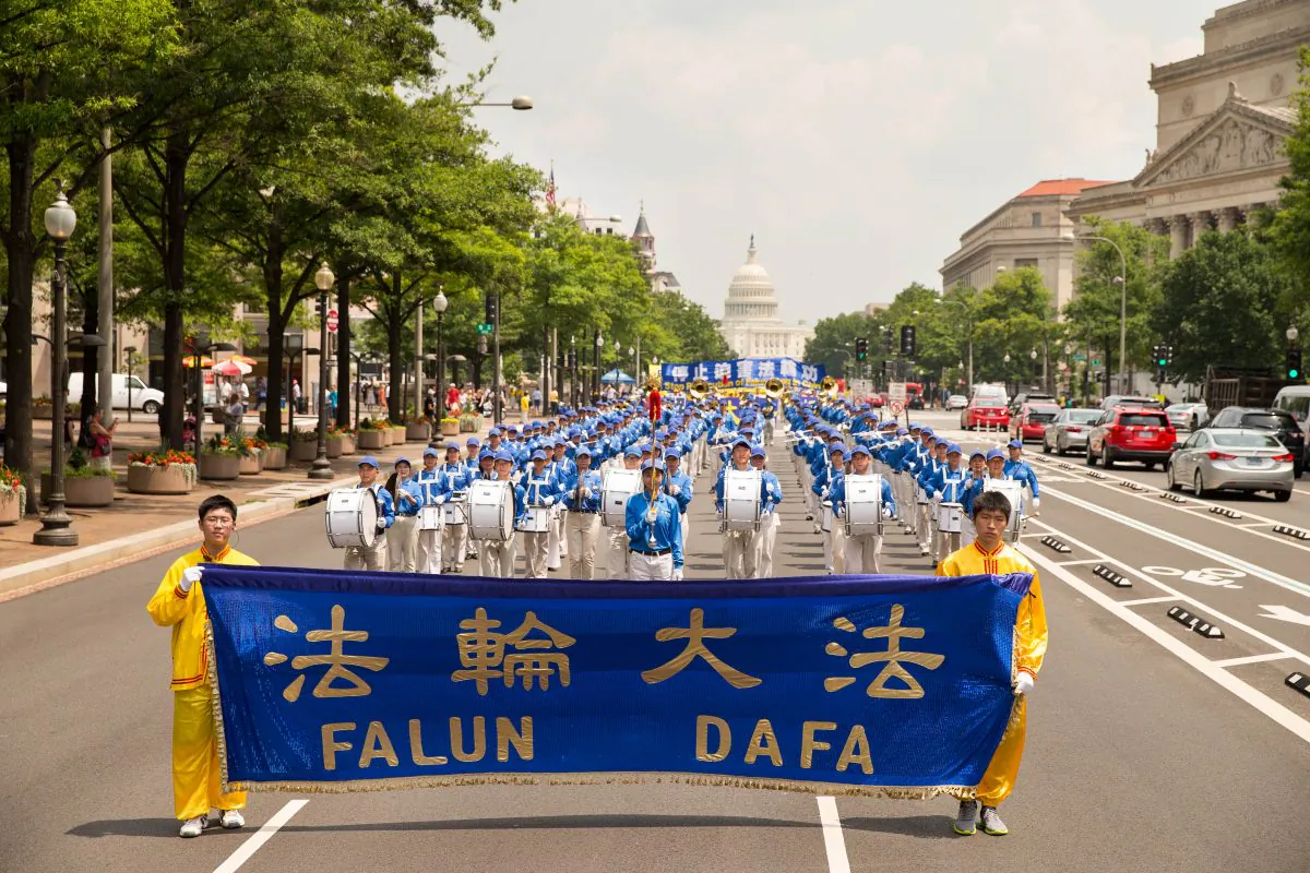 Hundreds of Falun Gong practitioners march in a parade in Washington D.C. on July 20, 2017. The parade is calling for an end to a brutal persecution in China that started on July 20, 1999. (Larry Dye/The Epoch Times)