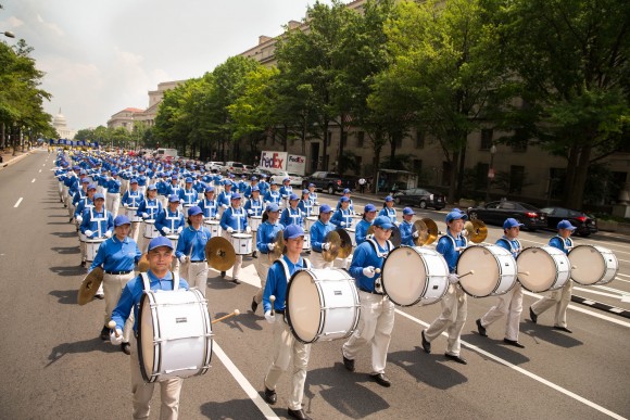 Hundreds of Falun Gong practitioners march in a parade in Washington D.C. on July 20, 2017. The parade is calling for an end to a brutal persecution in China that started on July 20, 1999. (Larry Dye/The Epoch Times)