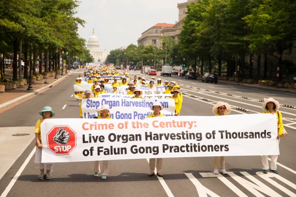 Hundreds of Falun Gong practitioners march in a parade in Washington D.C. on July 20, 2017. The parade is calling for an end to a brutal persecution in China that started on July 20, 1999. (Benjamin Chasteen/The Epoch Times)