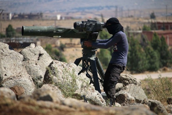 An opposition fighter looks for government forces' positions in Syria's southwestern Quneitra province on June 28, 2017. (MOHAMAD ABAZEED/AFP/Getty Images)