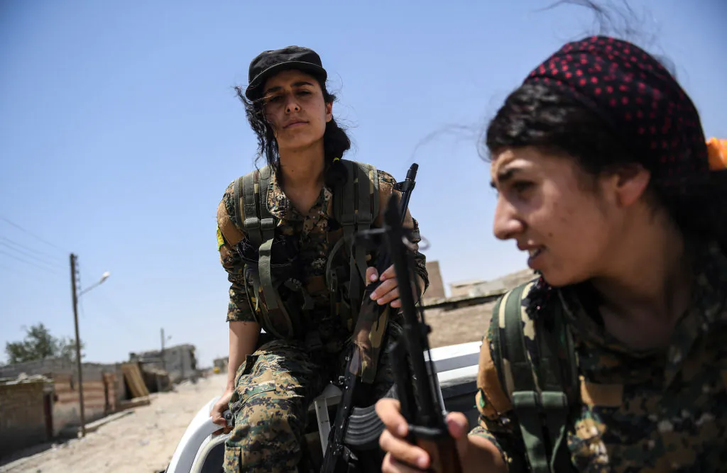 Members of the Women's Protection Units (YPJ) arrive on the frontline on the eastern outskirts of Raqqa on July 18, 2017. (BULENT KILIC/AFP/Getty Images)